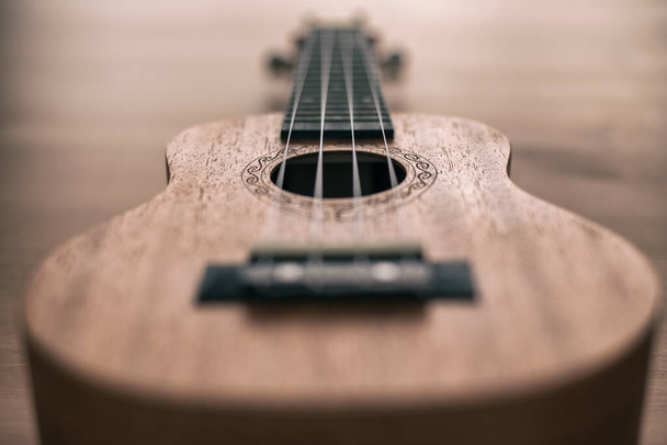 ukulele marrom no fundo de madeira com raso depht de campo - Foto, Imagem