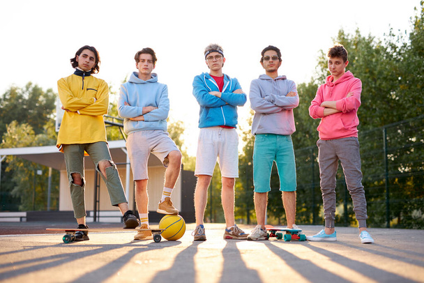 friendly group of caucasian teenagers boys ready to play basketball - 写真・画像