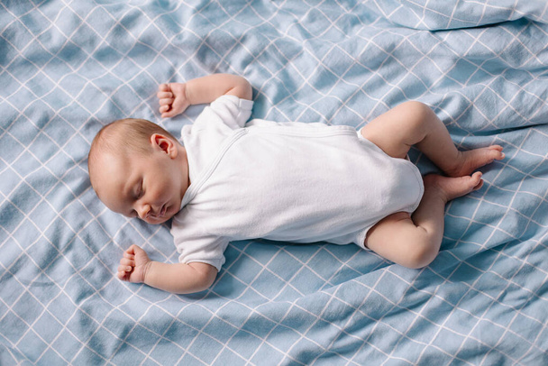 cute baby boy lying on bed - Фото, изображение