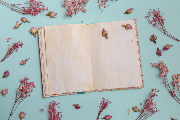  pink flowers flat lay with old notepad. Women's Day. View from above, Spring minimal concept. - 写真・画像