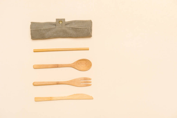 Set of Eco friendly bamboo cutlery on camel color background. Plastic free concept. Close-up, top view. - Foto, Bild