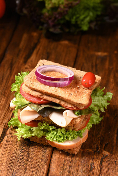 Big double sandwich on the wooden table. - Foto, immagini