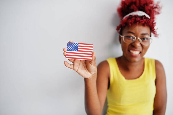 African american woman with afro hair, wear yellow singlet and eyeglasses, hold USA flag isolated on white background. - Foto, imagen