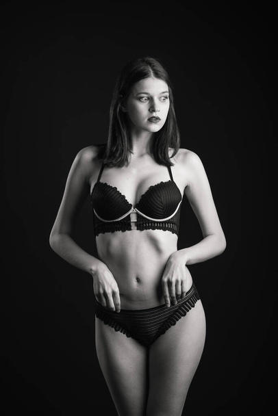Cute brunette female model posing, wearing black underwear in studio - Foto, immagini
