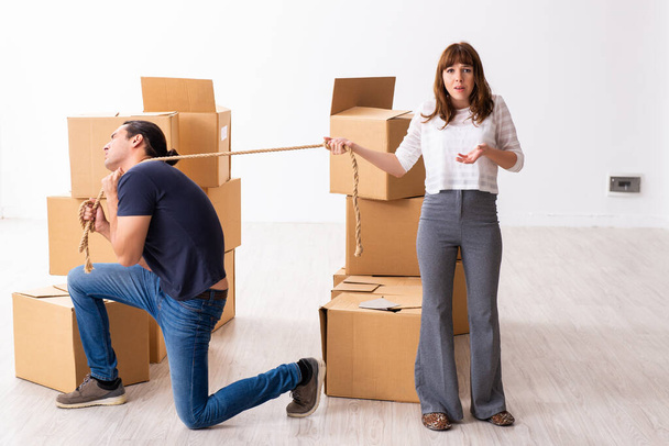Young pair and many boxes in divorce settlement concept - Foto, Imagem