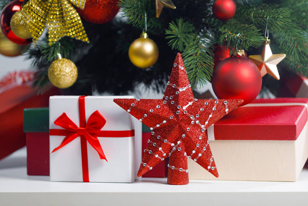 Christmas gifts and red decorative star on white background - Φωτογραφία, εικόνα