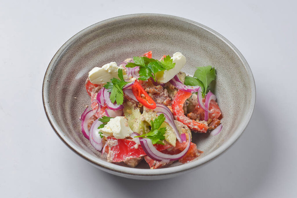 Bowl of fresh salad with mayonnaise. Meat, pepper, cheese and onions. Over white background. Close up. - Foto, imagen