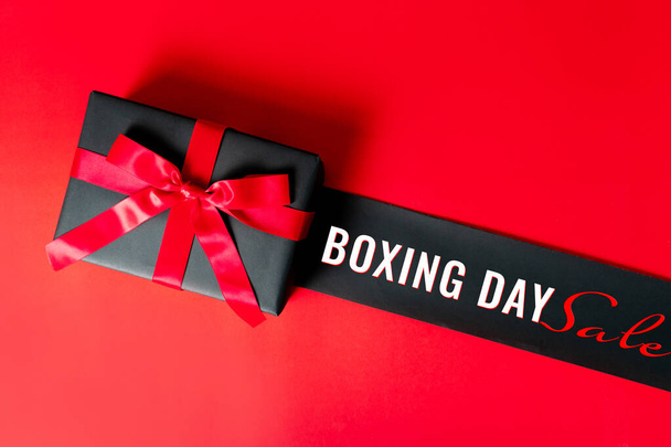 Boxing day Sale concept Christmas gift box on red background, top view - Photo, Image