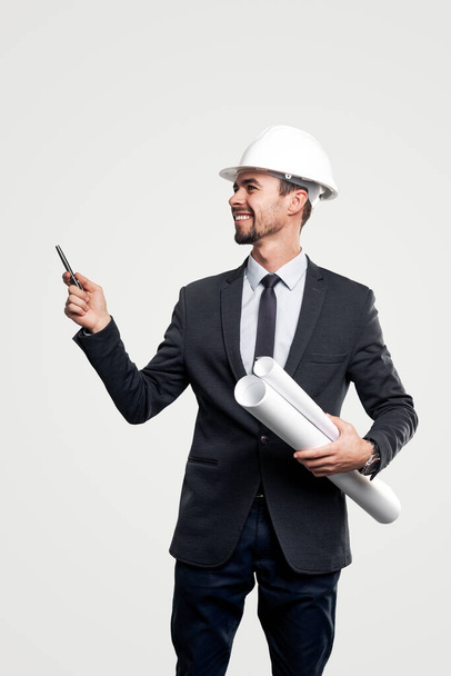 Happy male engineer pointing away - Фото, изображение