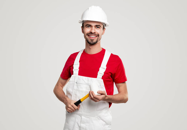 Happy repairman with hammer looking at camera - Fotoğraf, Görsel