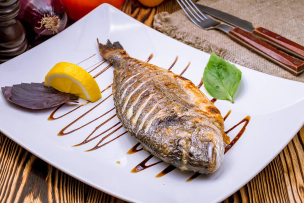 grilled cooked Dorado fish with lemon slice  - Photo, Image