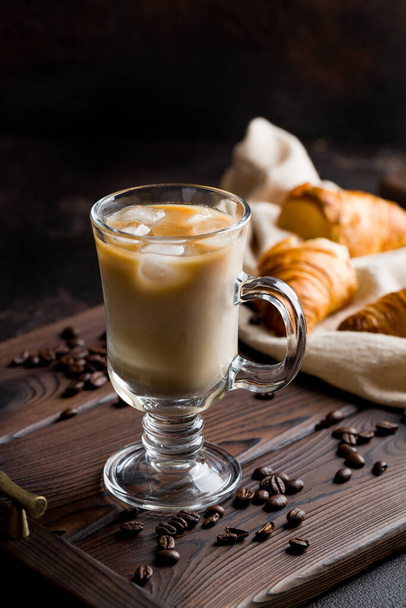 iced coffee with milk on dark wooden tray with croissants - Foto, Imagem