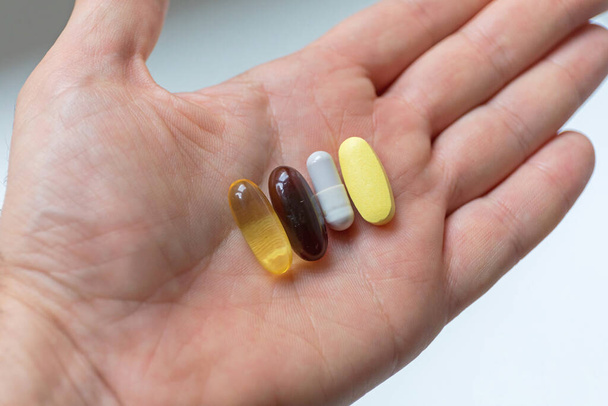 Vitamins Minerals and Supplements Pills in Hand - Fotoğraf, Görsel