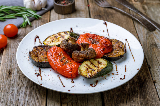 grilled vegetables on a plate on wooden background - Fotó, kép