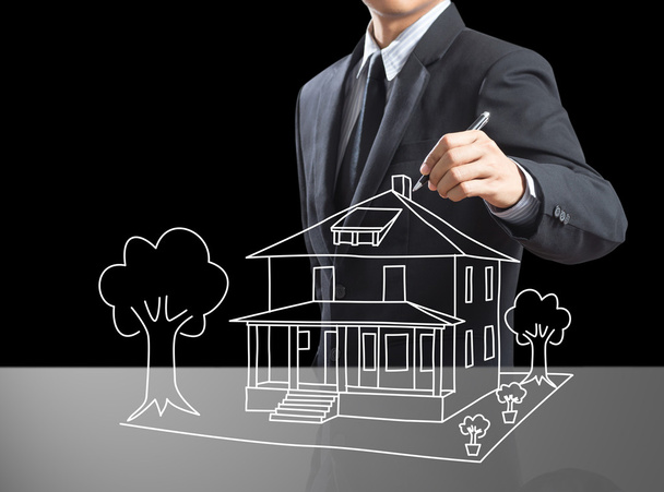 Business man drawing dream house on screen - Photo, Image