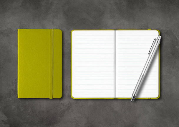 Olive green closed and open lined notebooks with a pen. Mockup isolated on dark concrete background - Fotó, kép