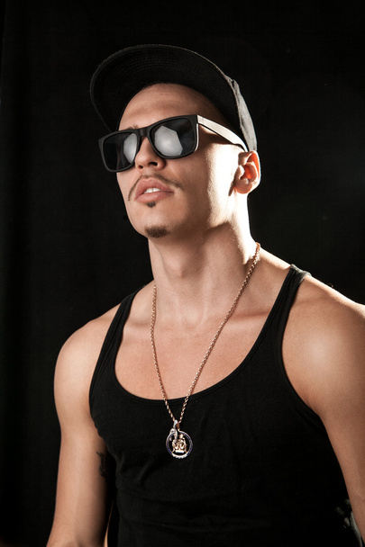 Glamour male model in sunglasses on black background - Фото, изображение