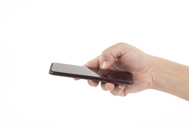 スマートフォンを持っている人の手と親指タッチスマートフォンの画面を使用して - 写真・画像