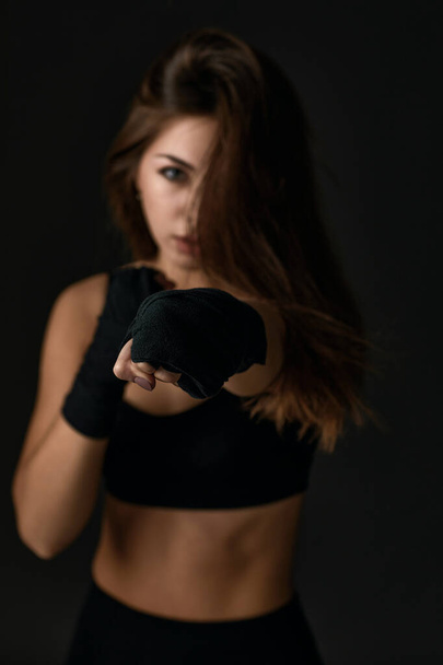 woman with boxing bandages punching - Foto, afbeelding