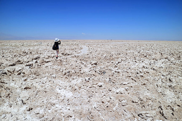 Female Traveler Taking Photos on the Trail of Salar de Atacama, Extensive Chilean Salt Flat at the Altitude of 2,305 M. in Antofagasta Region, Northern Chile - Фото, зображення