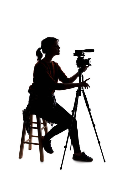 Silhouette of a female indie filmmaker, online content creator or casting director with a camera and mic on a white background - Photo, Image