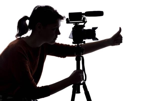 Silhouette of a female indie filmmaker, online content creator or casting director with a camera and mic on a white background - Фото, зображення