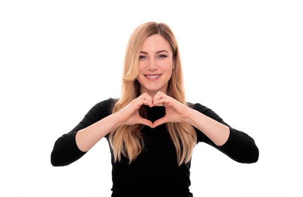 Woman shows heart sign with her hands. On white background. - Foto, Imagem