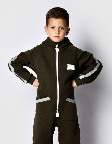 Boy in trendy warm sportive jumpsuit portrait - 写真・画像