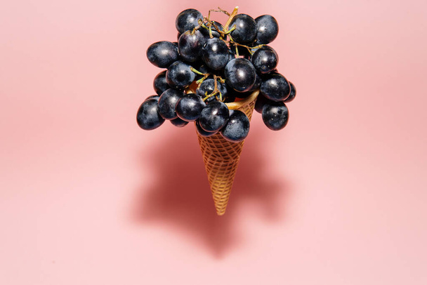 Floating ice cream cone with fresh grapes - Foto, afbeelding