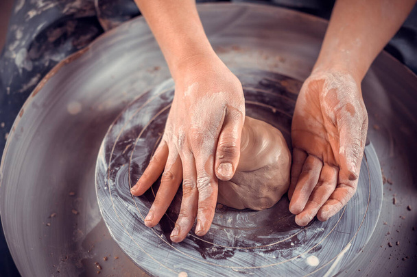 Potter female student working with pottery at the ceramic workshop. Concept for woman in freelance, business, hobby. Close-up. - Photo, Image