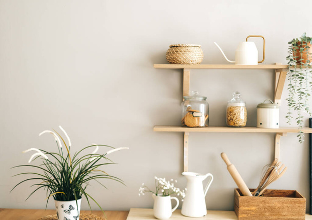 Grocery and kitchenware on the wooden shelves in modern bright kitchen. High quality photo - 写真・画像