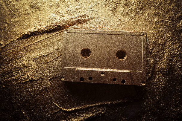 old audio cassette under gold dust - Photo, Image