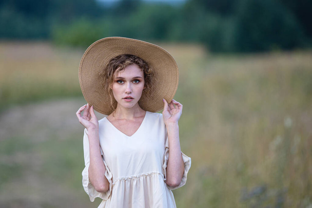 Beautiful summer girl a wheat field, a white dress, A sunny day. Teenage model summer holidays, vacation and people concept - 写真・画像