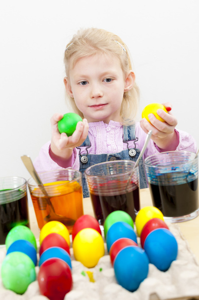 Litle girl coloring Easter eggs - Photo, image