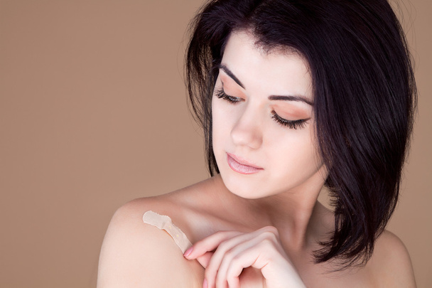 Girl peels shoulder patch, clear skin - Photo, Image