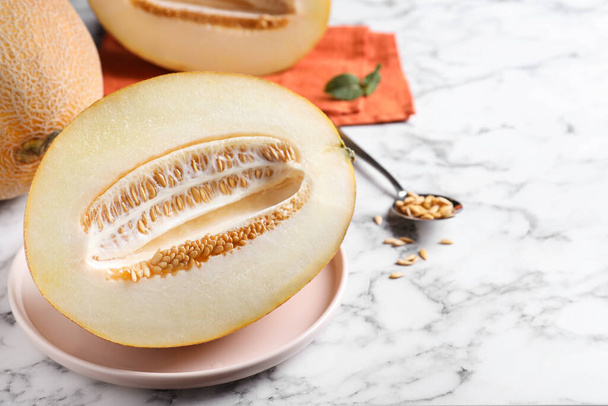 Delicious honey melon on white marble table - 写真・画像