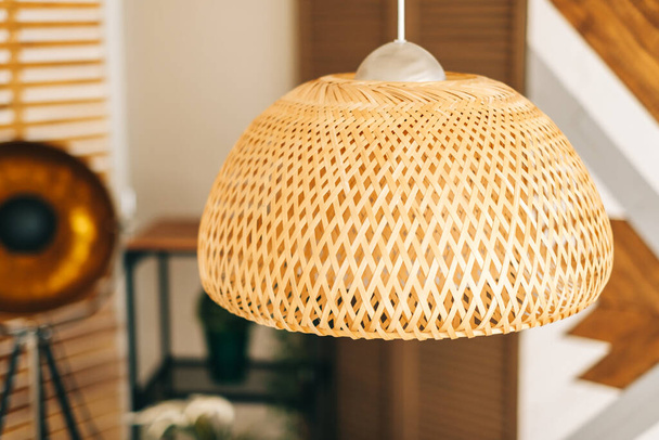Straw lampshade in modern living room. Eco-friendly interior design using natural materials. - Фото, зображення