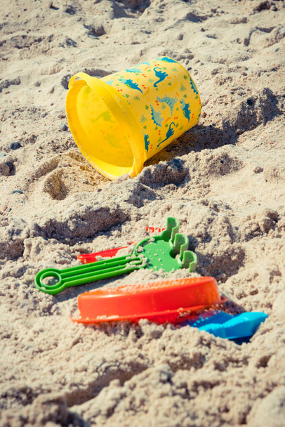 Different shapes made of sand and children toys for relax or playing on summer beach. Summer, vacation time and child development - Φωτογραφία, εικόνα