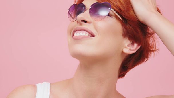Portrait of beautiful middle aged red head woman with heart shaped glasses. Beauty shot - Foto, immagini