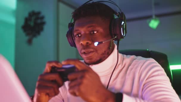Portrét záběr soustředěný mladý černoch profesionální herní hráč hraje videohry - Záběry, video