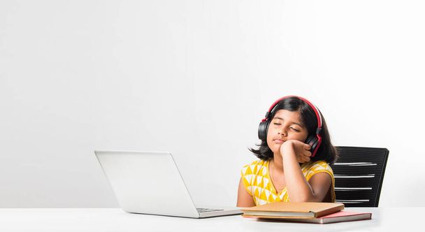 Pretty stylish Indian asian schoolgirl studying attending online lesson at home, social distance during quarantine, self-isolation, online education concept, home schooler - Φωτογραφία, εικόνα