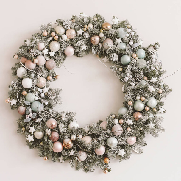 Wreath of spruce on white background. Christmas decorations. New Year holiday composition. Frame wreath mock up. Copy space  - 写真・画像