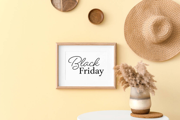 Frame with text "Black Friday" hanging on wall in room - Фото, изображение
