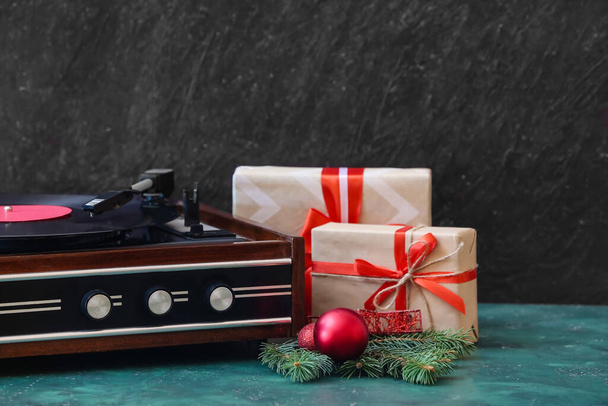 Record player and Christmas decor on table - Фото, зображення