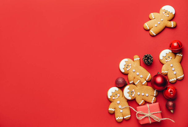 Tasty gingerbread cookies and Christmas decor on color background - Valokuva, kuva