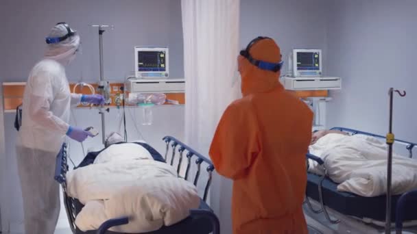 Leitender Arzt untersucht Coronavirus-Patienten in Quarantäne-Raum - Filmmaterial, Video