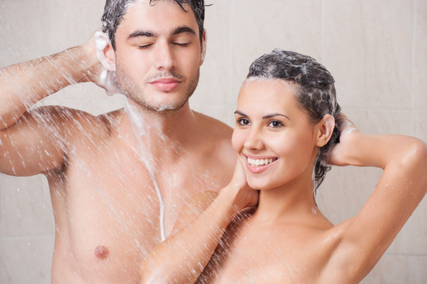 Beautiful couple washing in the shower - Foto, afbeelding