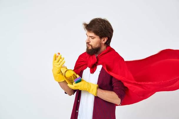 man with detergent in hands red raincoat professional service work - Foto, Imagen