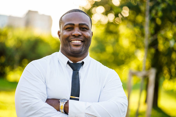 Portrait of happy african-american businessman who is looking at camera and smiling. - Photo, Image