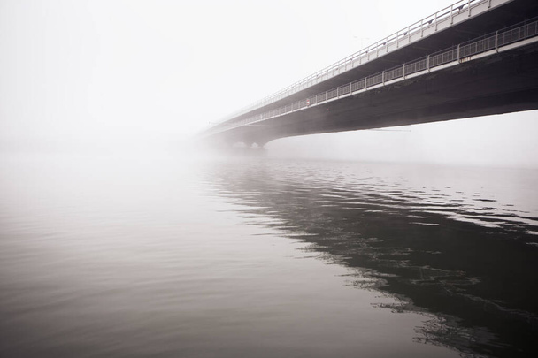 Fog over the river and bridge . Foggy weather in the autumn  - Photo, Image